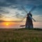 Windmill country landscape at sunset inspires with its beauty