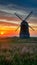 Windmill country landscape at sunset inspires with its beauty