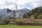 Windmill, crops and mountain in Crete, Greece