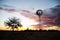 Windmill in desert sunset