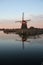 Windmill Eendragtsmolen reflection on the river Rotte at sunset in Zevenhuizen, the Netherlands