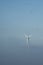 Windmill in foggy landscape. Renewable energy for environmentally conscious future