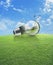 Windmill and forest inside light bulb with birds over green grass field and blue sky , Ecological concept