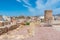 Windmill and fortress on Monte Sacro viewed from archeological park on cerro del molinete in Cartagena, Spain