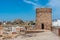 Windmill and fortress on Monte Sacro viewed from archeological park on cerro del molinete in Cartagena, Spain