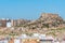 Windmill and fortress on Monte Sacro viewed from archeological park on cerro del molinete in Cartagena, Spain