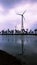 Windmill generating energy in dusk in silhouette