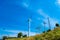 Windmill generator in wide yard / Yard of windmill power generatorunder blue sky, shown as energy industry concept.