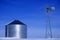 Windmill and Grain Silos in Winter Snow on Farm for Agricultural Farming