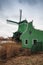 Windmill and green barn on Zaan river coast