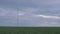 windmill in a green field isolated on a beautiful landscape, generating electricity, on the right there is a place for