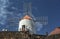 a windmill integrated into the landscape of a cactus garden in lanzarote