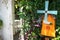 Windmill mailbox on a wooden fence