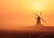 Windmill in the mist. Windmill in foggy colorful sunrise in the countryside.