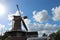 Windmill named Windlust in Nieuwerkerk aan den IJssel with blue sky and white clouds