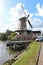 Windmill named Windlust in Nieuwerkerk aan den IJssel with blue sky and white clouds