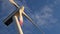 Windmill power generator at sunset with blue sky