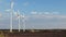 Windmill power generators at sunset with blue sky