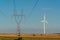 Windmill and powerline on the field