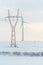 Windmill and powerlines on the field in winter