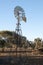 Windmill pumping water from artesian basin in the late afternoon sun