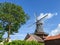 Windmill in the `Rundwarftendorf` Rysum, East Frisia, Germany