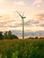 Windmill on rural field in the sunset. Wind turbines farm