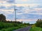 Windmill on rural road in the sunset. Wind turbines farm.