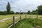 A windmill seen in the distance by the river Rother, seen in Rye, Kent, UK