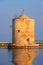 Windmill seen from the side of the orbetello lagoon in tuscany area in Italy