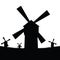 Windmill silhouette with grass