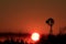 Windmill silhouette at Sunset with a blazing red sky out in the country