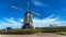 Windmill surrounded by a wood fence on a wonderful sunny day