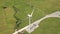 Windmill turbine on green field background. Drone view wind power turbine generation on energy station. Alternative