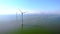 Windmill turbines at sea seen from a drone aerial view from abov