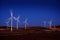 Windmill Wind Turbine Spinning in Wind at Sunset or Sunrise