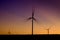 Windmill Wind Turbine Spinning in Wind at Sunset or Sunrise