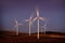 Windmill Wind Turbine Spinning in Wind at Sunset or Sunrise