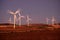 Windmill Wind Turbine Spinning in Wind at Sunset or Sunrise