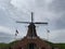 Windmill with Windswept Clouds and Blue Sky in Fulton, Illinois - Landscape View