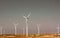Windmills against a dramatic blue sky. Renewable energy, alternative electricity