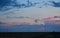 Windmills against a rainbow evening sky