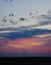 Windmills against a rainbow evening sky