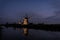 Windmills along the water in Kinderdijk at twilight