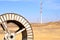 Windmills in the backdrop of a winding wheel on the way to Sam Sand Dunes Thar Desert from Jaisalmer, Rajasthan, India. The