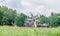 Windmills close up, green forest, wild vegetation, blue clouds s