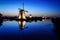 Windmills at dusk under a blue sky