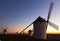 Windmills at field in dusk