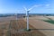 Windmills on the field with hay bales