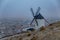 Windmills in the fog in Consuegra town in Spain